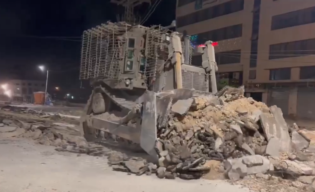 An IDF bulldozer checks for explosive charges beneath roads approaching the Nur Shams camp near Tulkarem (Screenshot)